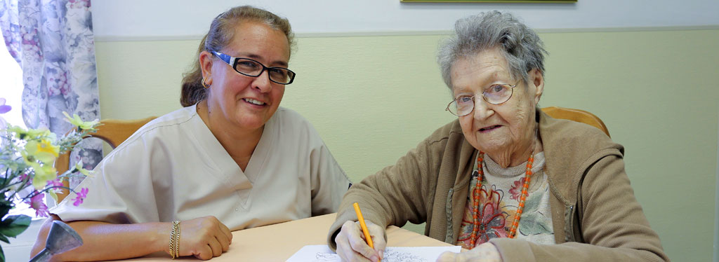 Staff Member and Resident Writing